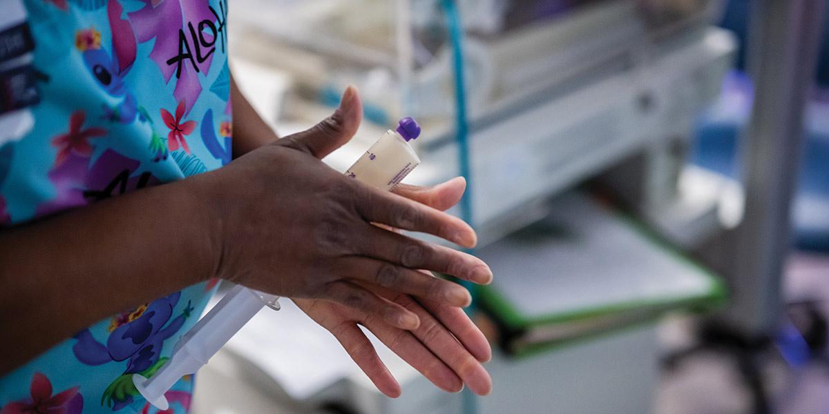COLOSTRUM — the first milk, rich with antibodies — is handled with care. Though advanced machines can do the work, this nurse prefers to warm and mix it by hand, a method honed through years of caring. Below, NICU physicians review each baby’s progress several times a day, adjusting ventilator settings, feeds and medication based on even small changes.