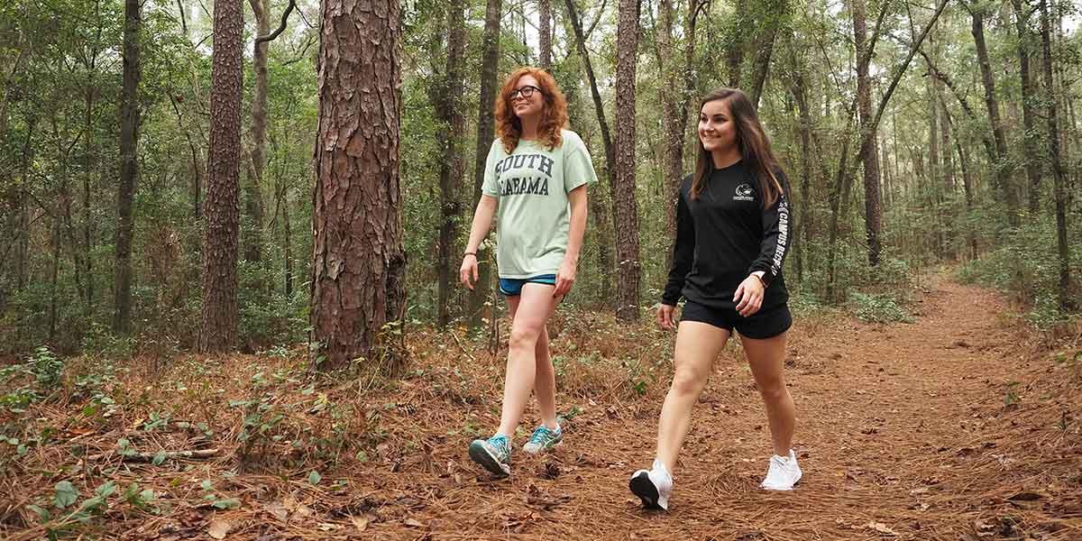 Two students walking the nature trail.