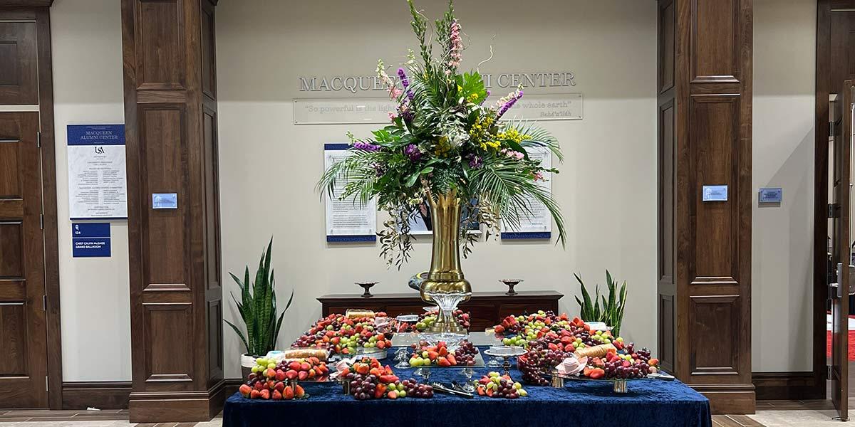 large table with fruit and large centerpiece 