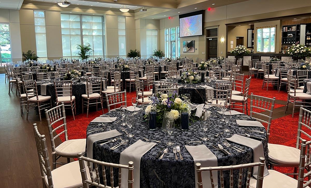 Tables set up with black and silver decorations.