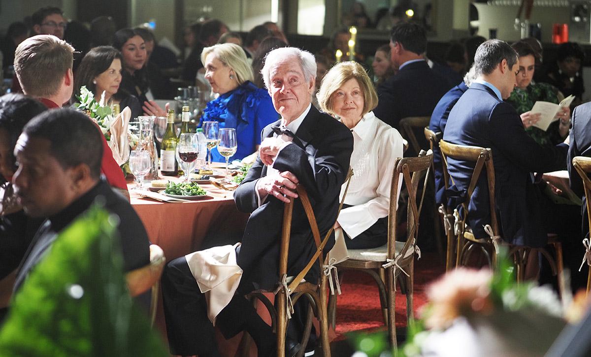 Moulton smiling at table.