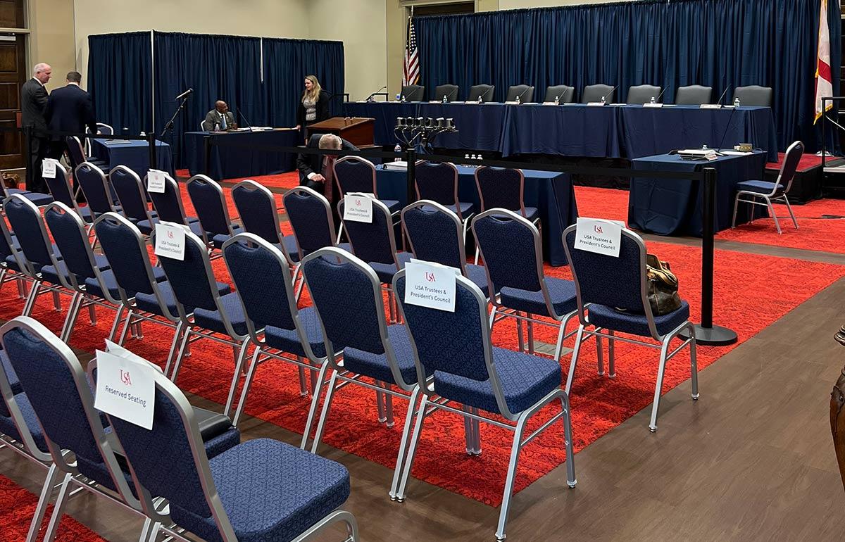 Chairs set up for event in ballroom.