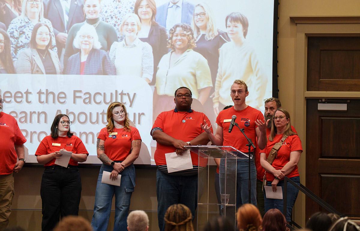 Political Science and Criminal Justice group on stage in ballroom speaking.