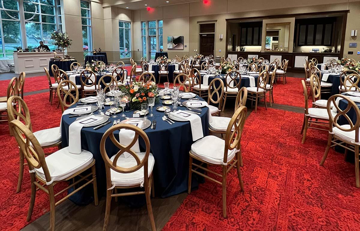 Gold chairs with blue table cloths
