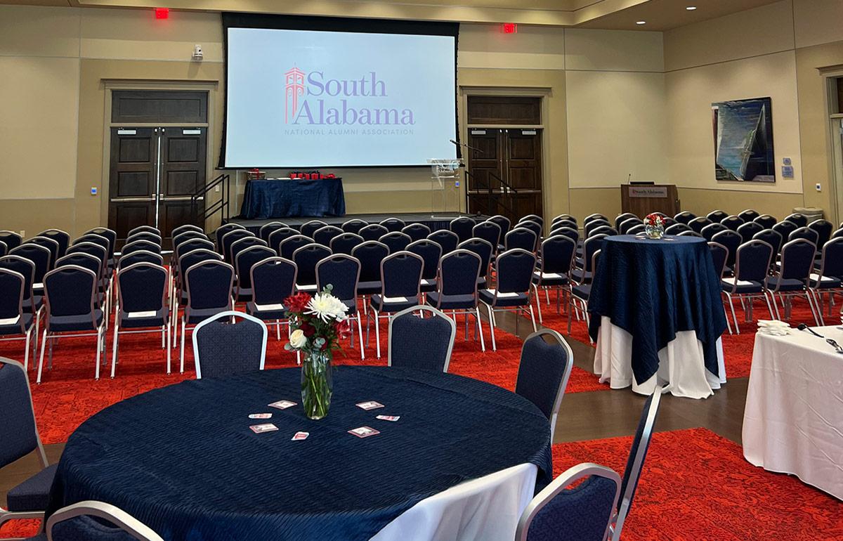 Tables and chairs set up with screen.