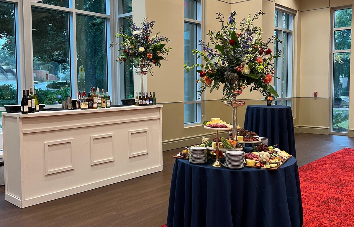 Bar set up at event with cocktail tables.