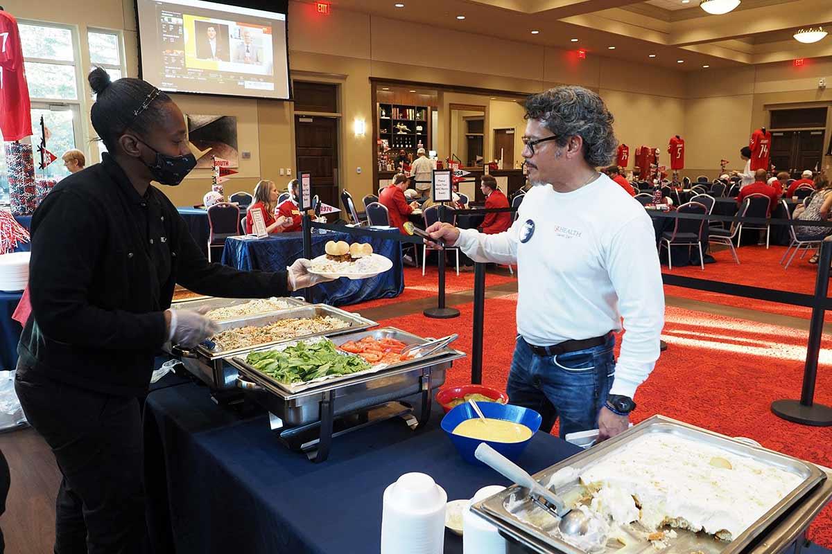 A man getting tailgating food