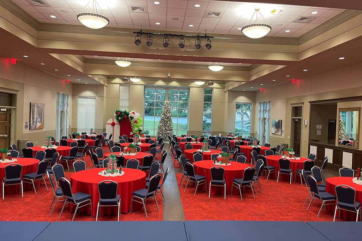 Tables set with blue tablecloths and holiday decor 