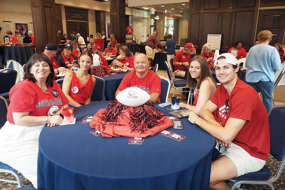 Tailgating group at table with football centerpiece