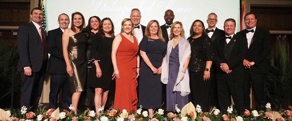 Group image of alumni board at awards ceremony.