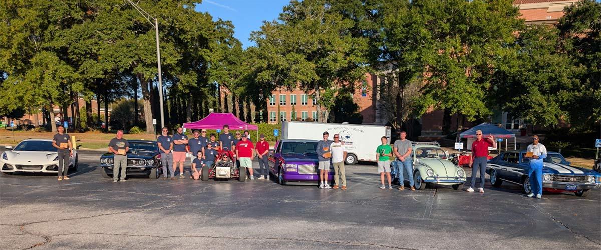 Jag Racing students in front of school with their cars.