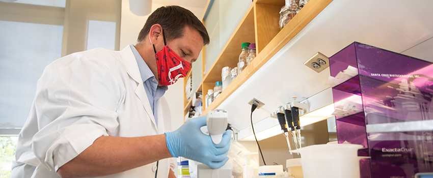 Kevin Lee, Ph.D., assistant professor of research, works in a lab at the Mitchell Cancer Institute.