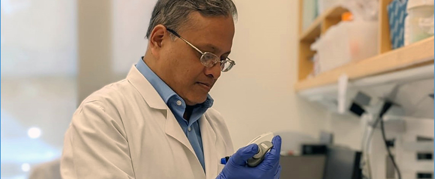 Dr. Dasgupta working in lab.