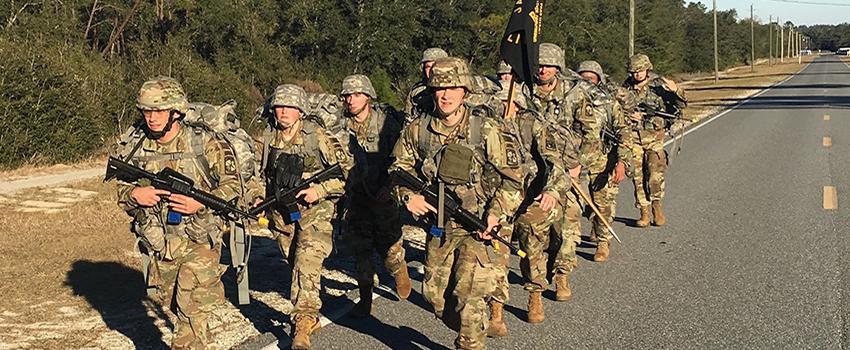Rangers running holding flag and carrying guns