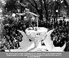 Folly dances atop a glass of champagne on Knights of Revelry float, Beinville Square, Mobile, AL Bardi Gras Day, 1940