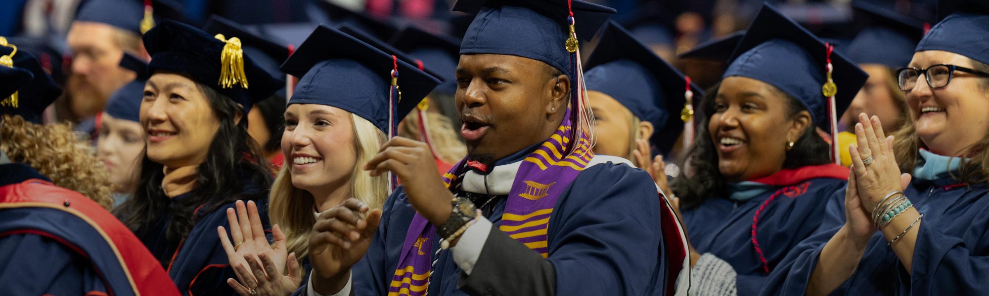 Male and female graduates celebrating commencement