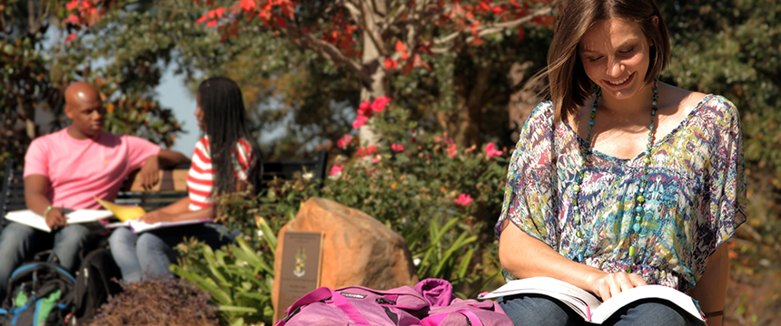Girl sitting on Meisler Hall lawn