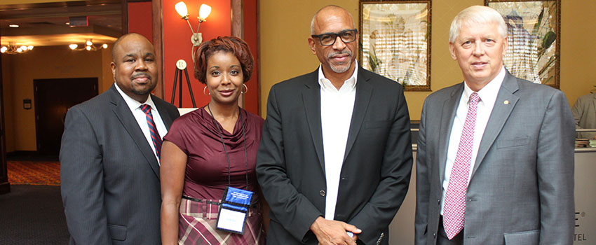 Dr. Green and Dr. Waldrop with two people at conference.