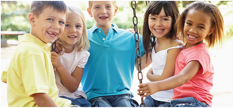 Five young kids sitting on tire swing