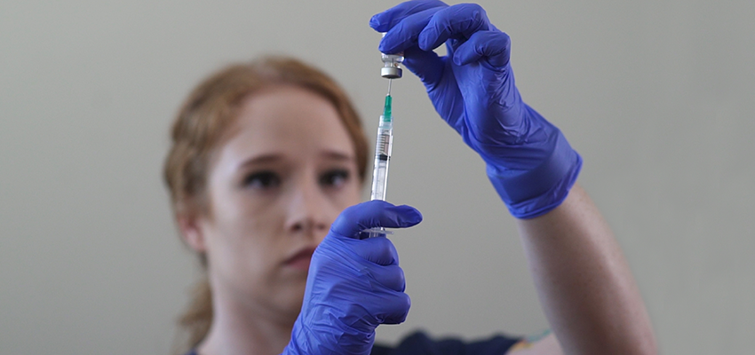 Image of EMS student getting a syringe ready.