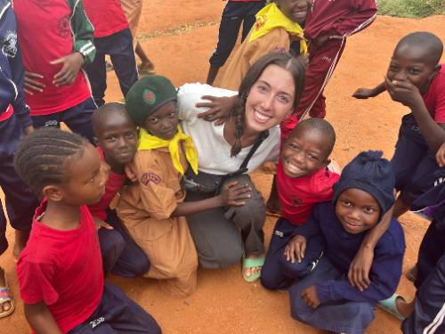 Study Abroad student with children of Kenya surrounding her.