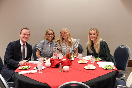 Group at table at honors ceremony.