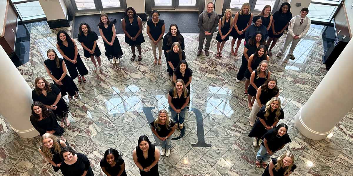 Occupational Therapy Students standing in OT shape.