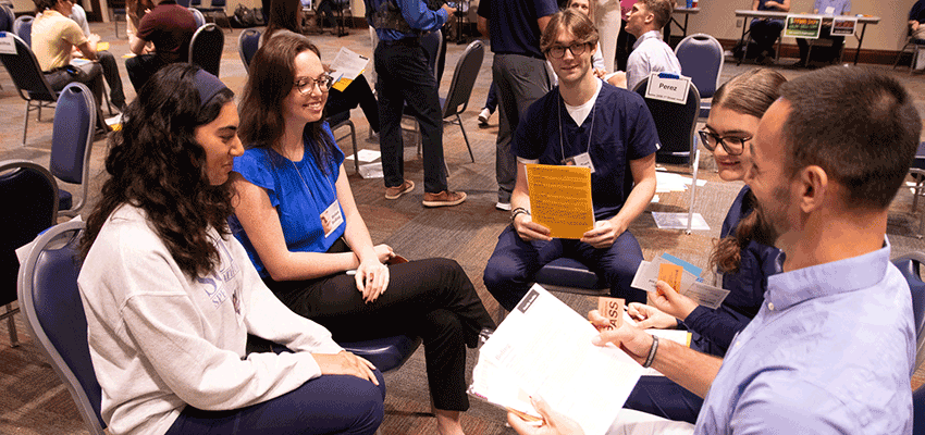 Students participating in a Community Action Poverty Simulation.