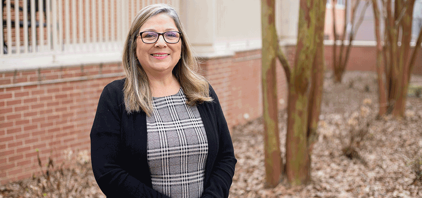 Catherine Cooper standing outside on campus.