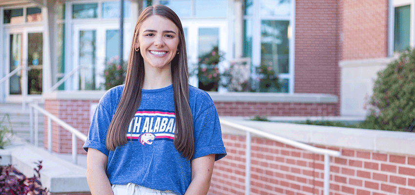 Ellie McCully standing in front of the Allied Health building.