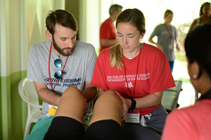 Brenton instructs a PT student in assessment of the knee.