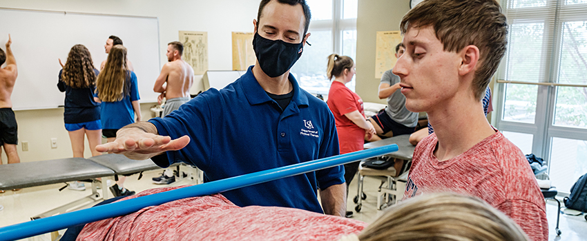 Image of PT Instructor and student in lab.