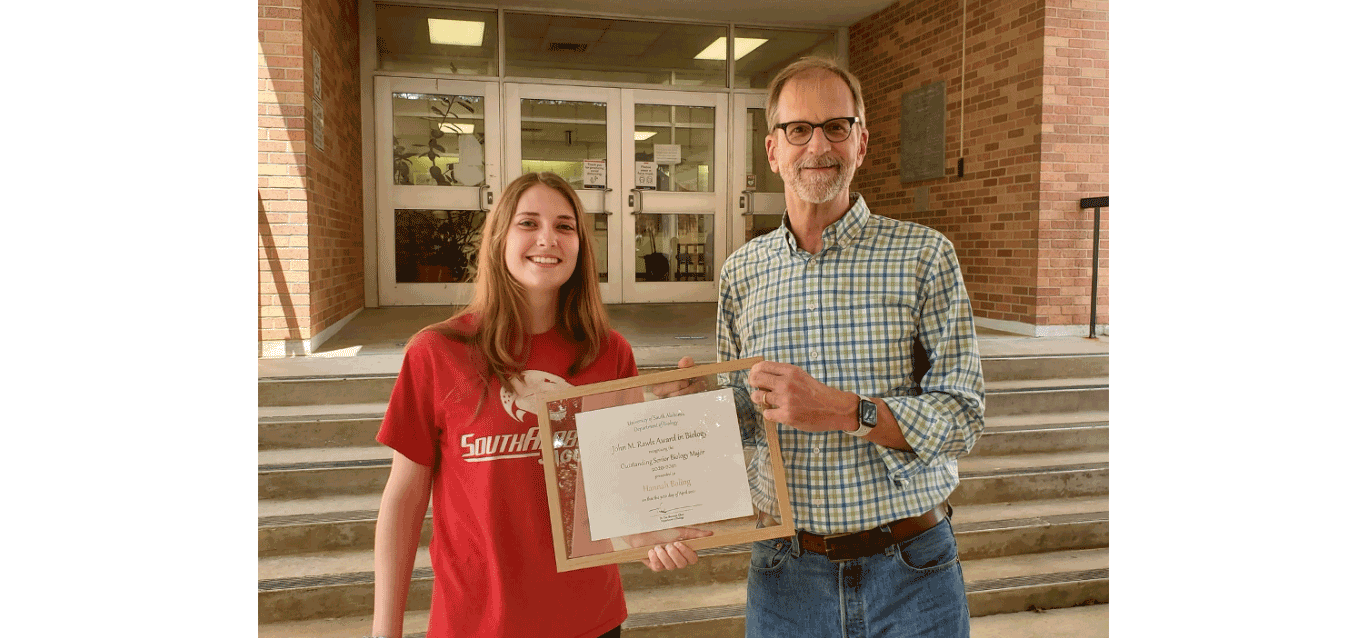 Photo of Hannah Boling (left) receiving the Rawls Award from Biology Department Chair Dr. Timothy Sherman (right) as the most outstanding senior biology major.