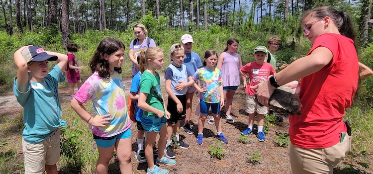 Photo of Dawn Canterbury talking to students about Gopher Tortoises in the Mobile Botanical Gardens.