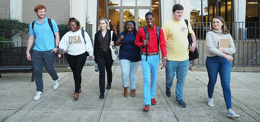 Communication students walking out of communication building.