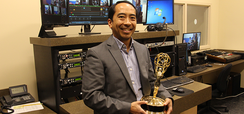 Andrew Hongo holding Emmy award