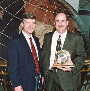 Dr. David Johnson (r), Dean of the College of Arts and Sciences, receives the Coastal Weather Research Center's 2003 Service Award from Dr. Bill Williams (l).