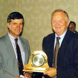Dr. Glen Sebastian receives the Coastal Weather Research Center's 1999 Service Award