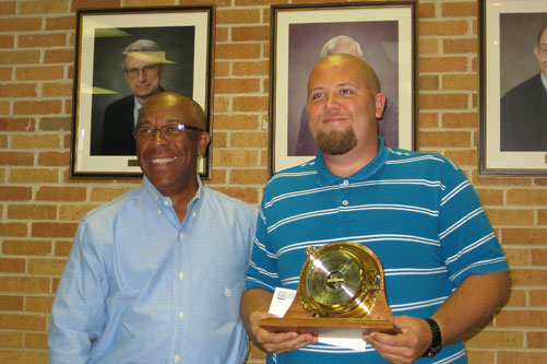Corey Bunn (right) accepts the 2011 ExxonMobil Academic Award as the outstanding meteorology senior from Richard Benjamin of ExxonMobil.