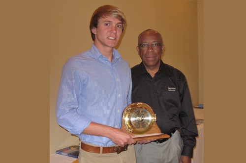 Trey Alvey (left) accepts the 2012 ExxonMobil Academic Award as the outstanding meteorology senior from Richard Benjamin of ExxonMobil.