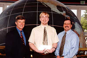 Jason Beaman (c) receives the 2002 ExxonMobil Junior Scholarship Award from Keith Hebert (r) of ExxonMobil and Dr. Bill Williams (l).