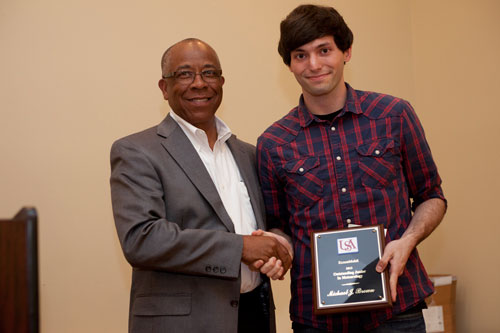Michael Brown (right) receives the 2013 ExxonMobil Scholarship Award from Richard Benjamin of ExxonMobil.