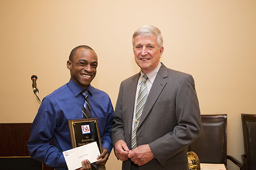 Kashawn Sinkler receives a PowerSouth Academic Scholarship from Dr. Bill Williams.