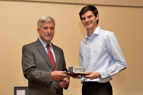 Dr. Bill Williams presents an Outstanding Senior Award to Adam Olivier.