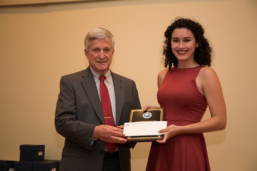 Dr. Bill Williams presents an Outstanding Senior Award to Alysa Carsley.
