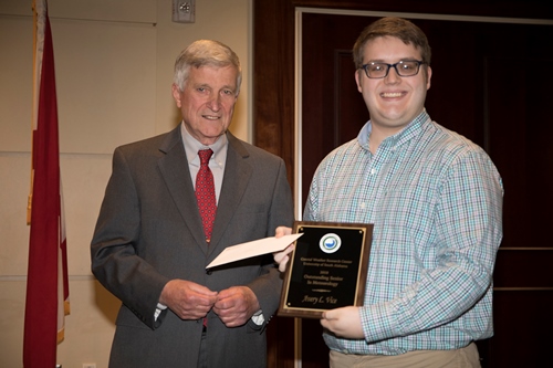 Dr. Bill Williams presents an Outstanding Senior Award to Avery Vice.