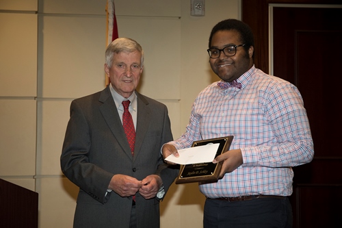 Dr. Bill Williams presents an Outstanding Senior Award to Jaylin Schley.
