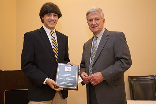 Dr. Bill Williams presents an Outstanding Senior Award to Nicholas Grondin.