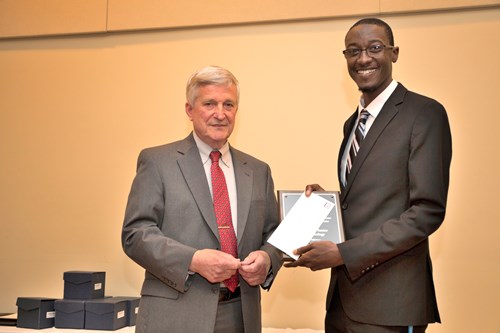 Dr. Bill Williams presents an Outstanding Senior Award to Tommie Owens.