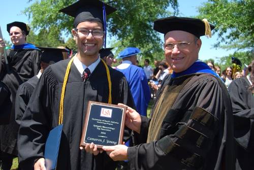 Cameron Young receives the 2016 Top Forecaster Award from Dr. Keith Blackwell.